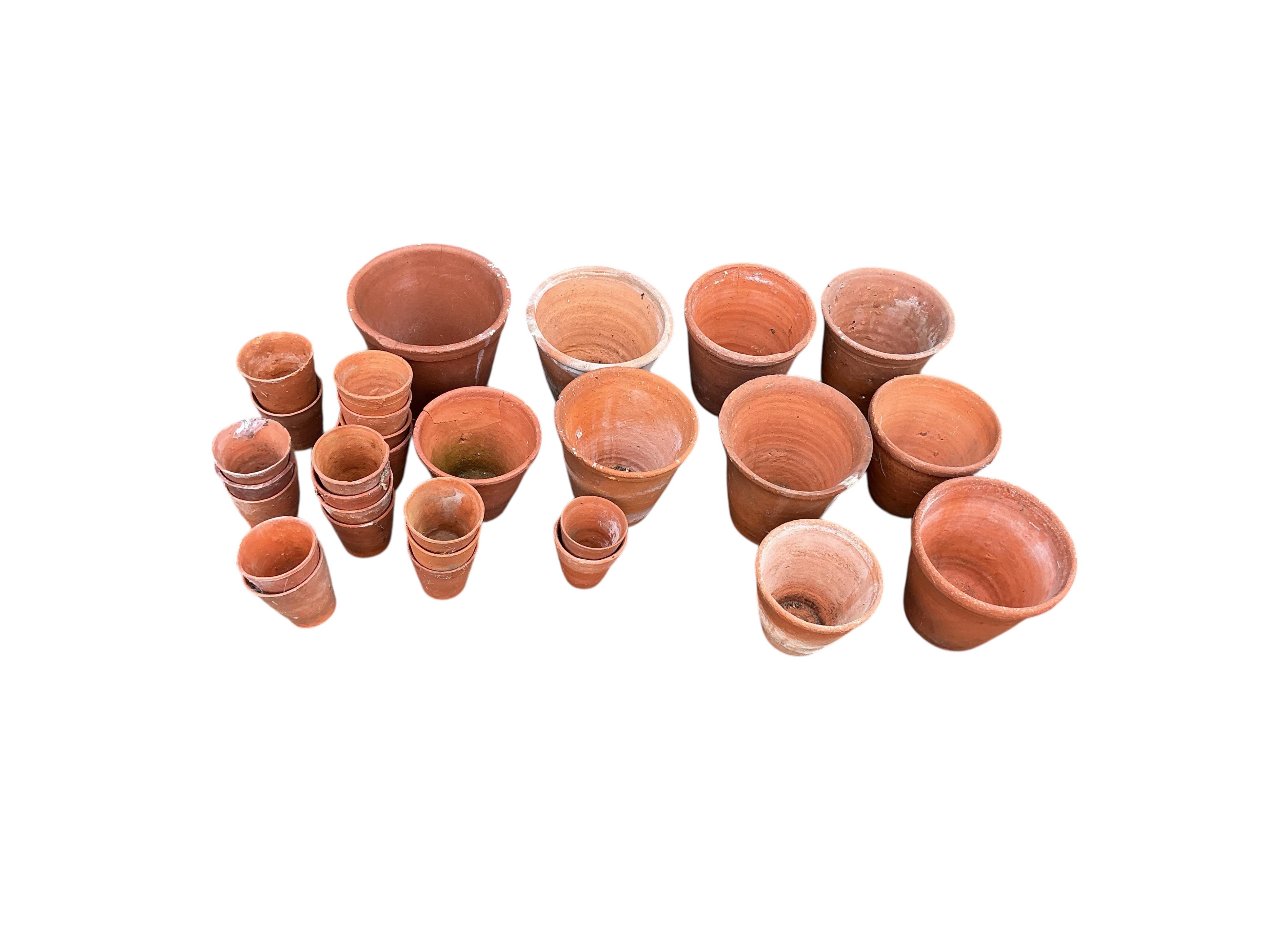 Thirty assorted circular terracotta garden pots, largest height 18cm